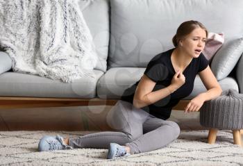 Woman having panic attack at home�