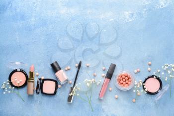 Set of makeup cosmetics on color background�