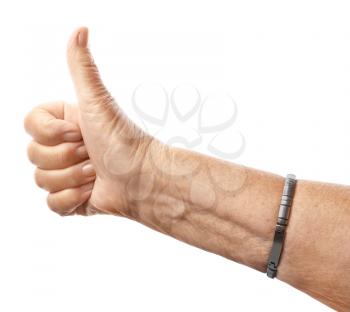 Hand of elderly woman showing thumb-up gesture on white background�