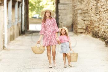 Beautiful woman and her little daughter outdoors�