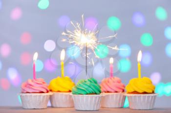 Tasty Birthday cupcakes against defocused lights�