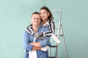 Happy young couple doing repair in their new house�