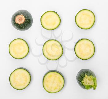Composition with fresh cut zucchini on white background�