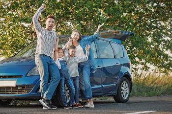 Happy family near car outdoors�