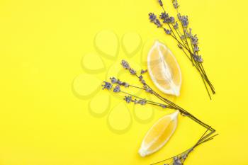 Beautiful lavender flowers with lemon pieces on color background�