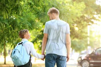 Little boy going to school with his father�
