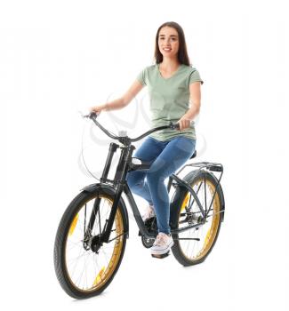 Beautiful young woman riding bicycle against white background�