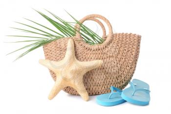 Beach bag, flip-flops and starfish on white background�
