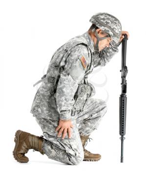 Mature male soldier mourning for his dead comrade on white background�