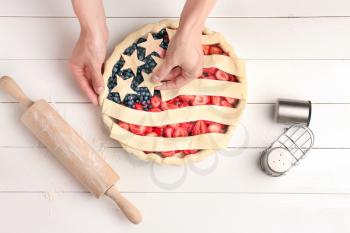 Woman making American flag pie in kitchen�
