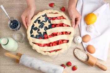 Woman making American flag pie in kitchen�