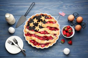 Tasty American flag pie and ingredients on table�