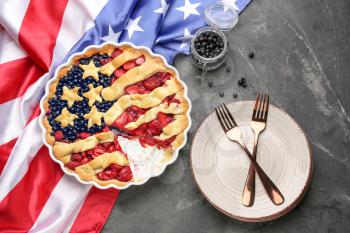 Tasty American flag pie and plate on grey background�