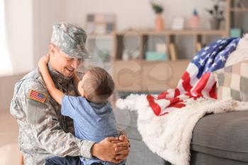 Happy military man with his son at home�