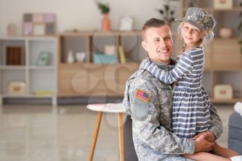 Happy military man with his daughter at home�