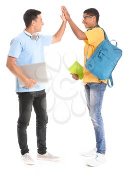 Portrait of young students giving each other high-five on white background�