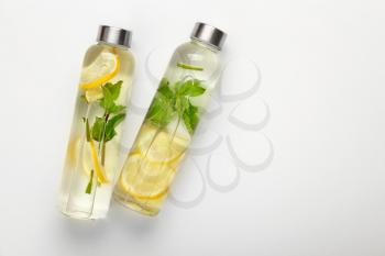 Bottles of fresh infused water on white background�