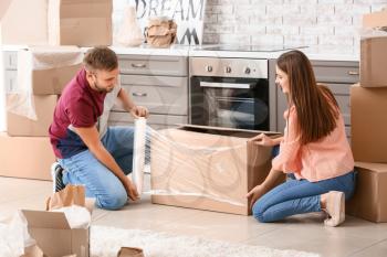 Young couple packing things before moving into new house�