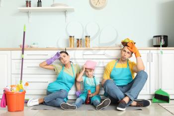 Tired family after cleaning kitchen together�