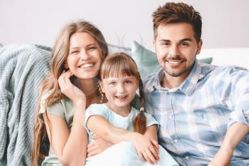 Portrait of happy young family at home�