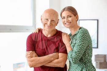 Young woman visiting her elderly father in nursing home�