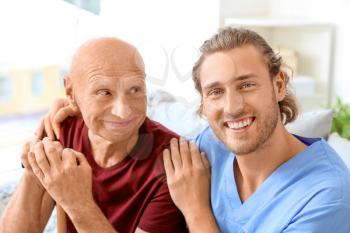 Elderly man with caregiver in nursing home�