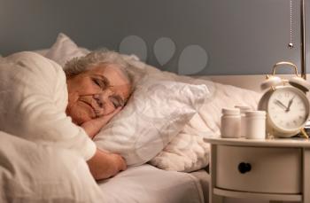 Senior woman sleeping in bed at night�