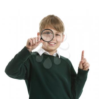 Little boy with magnifying glass and raised index finger on white background�