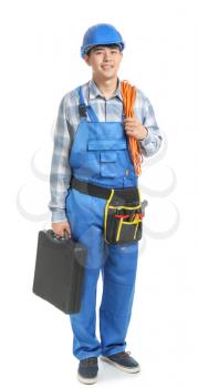 Male electrician with tools on white background�