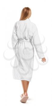 Beautiful young woman in bathrobe on white background, back view�