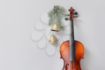 Violin and Christmas decor on light background�