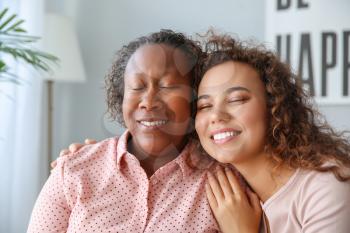 Portrait of African-American woman with her daughter at home�