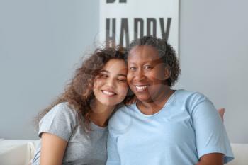 Portrait of African-American woman with her daughter at home�