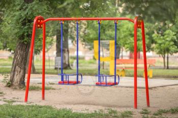 Swings on playground in park�