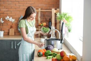 Woman using modern multi cooker in kitchen�
