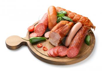 Wooden board with assortment of sausages on white background�