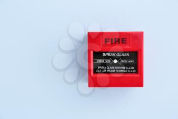 Modern manual call point of fire alarm system on color wall�