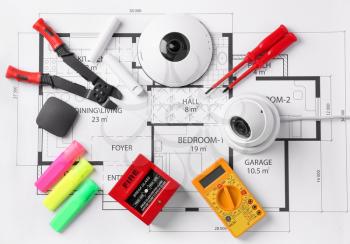 Different equipment of security system and tools for wiring on home plan�