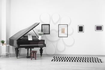 Black grand piano in interior of room�