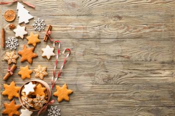 Composition with tasty Christmas cookies on wooden background�