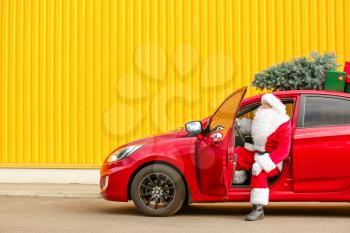 Santa Claus with modern car outdoors�