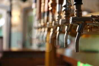 Draft beer taps in modern bar�