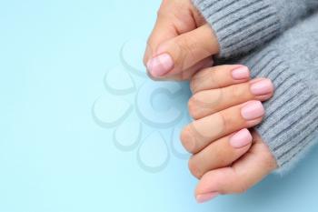 Hands of woman with beautiful manicure on color background�