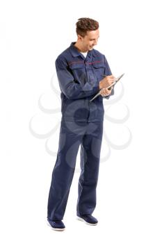 Male car mechanic with clipboard on white background�