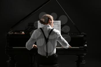Man playing grand piano at the concert�