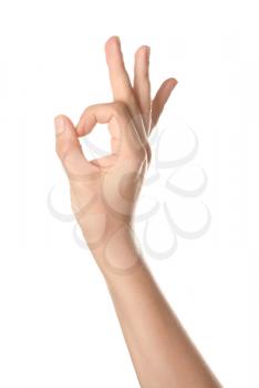 Female hand showing OK gesture on white background�