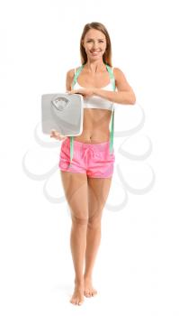 Beautiful young woman with scales and measuring tape on white background. Weight loss concept�