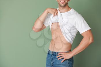 Handsome muscular man on color background. Weight loss concept�