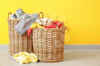 Baskets with dirty laundry on floor�