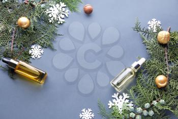 Christmas composition with essential oil for spa treatment on grey background�